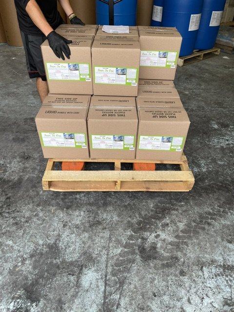Cases stacked and strapped to the pallet before wrapping.